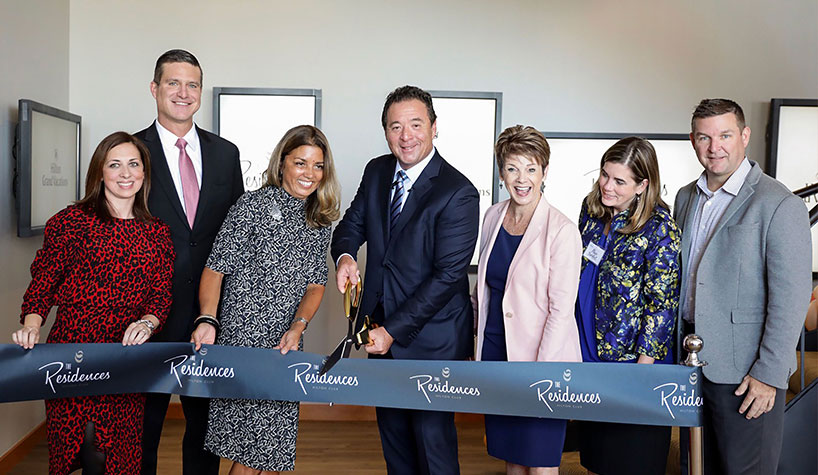 Mark Wang, president/CEO, (center) cuts ribbon with Hilton Grand Vacations' leaders.